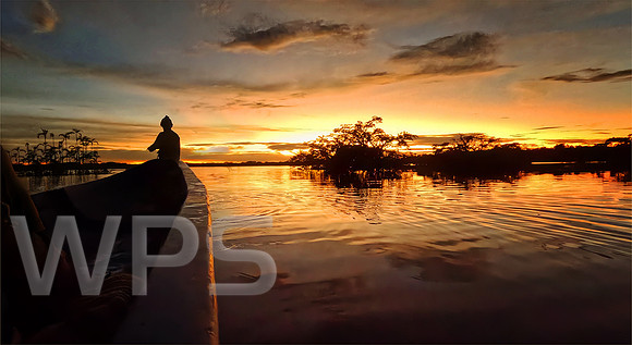 Canoeing at Sunset over Cuyabeno