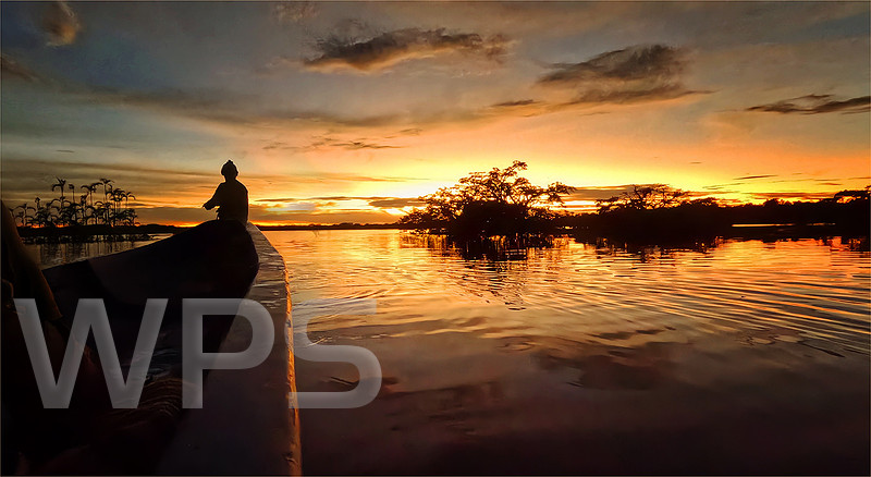 Canoeing at Sunset over Cuyabeno